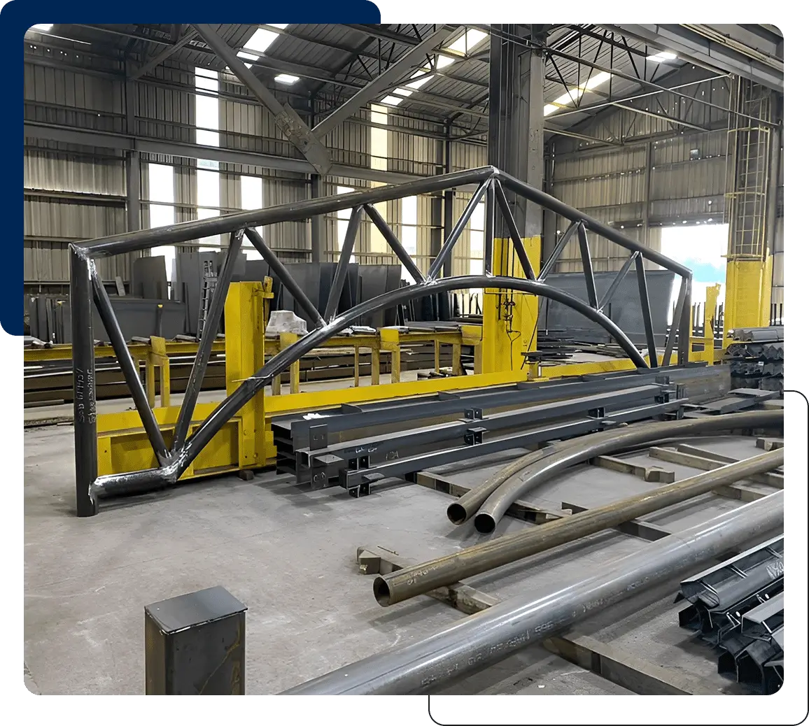 Large metal framework structure in an industrial workshop.